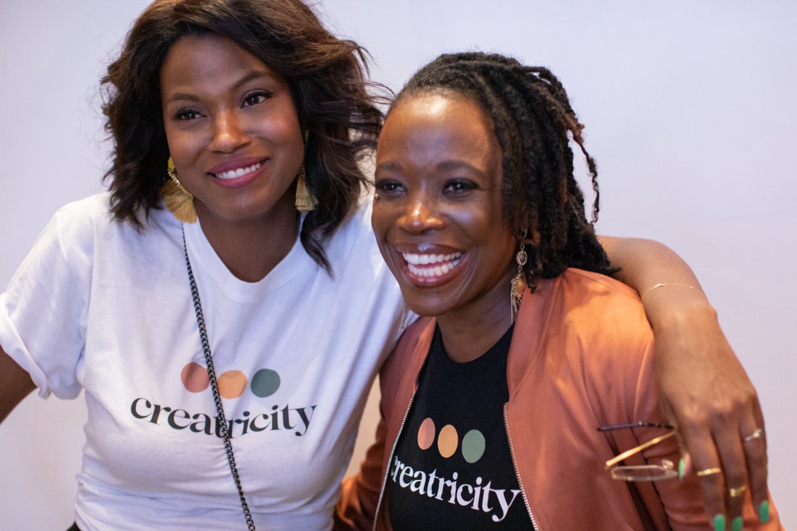 Two members in Creatricity shirts at an event